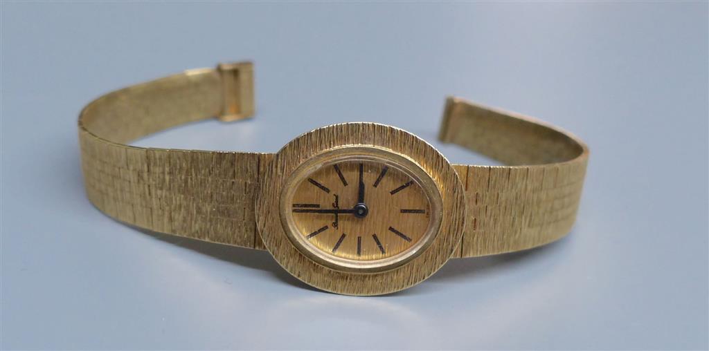 A ladys 9ct gold Bueche Girod manual wind wrist watch, on a textured 9ct gold bracelet, 15.7cm, gross 23.5 grams.